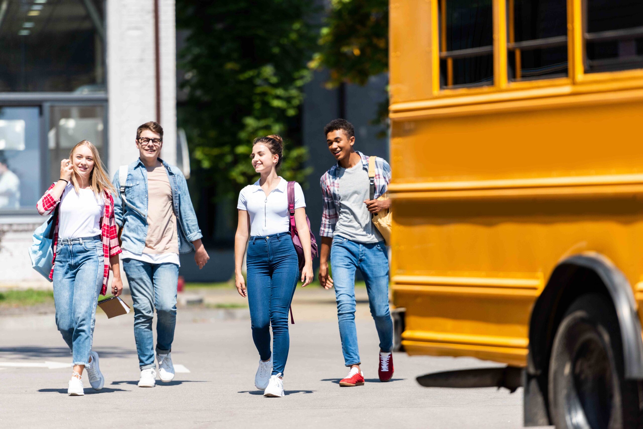 group-of-teen-scholars-walking-behind-school-bus-o-2023-11-27-05-20-32-utc_11zon